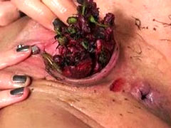 Experienced masochist nails her own tits and pussy to the wooden board